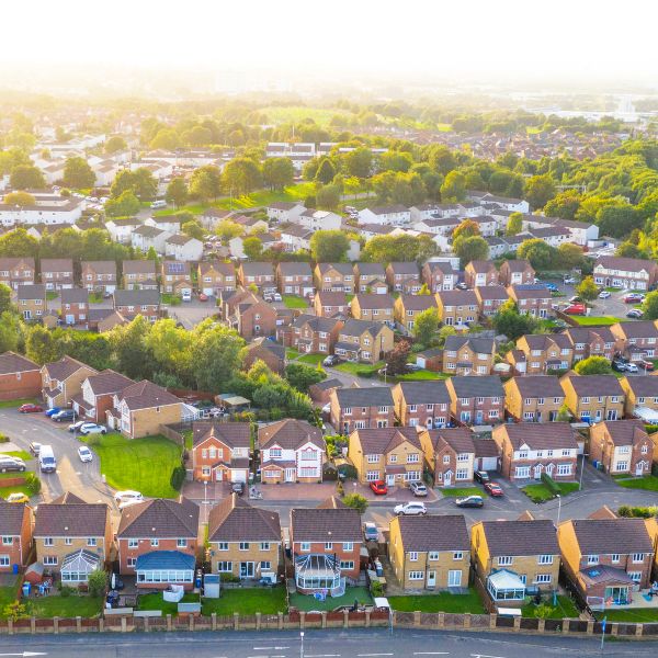 An aerial view of a British residential neighborhood with many brick homes.